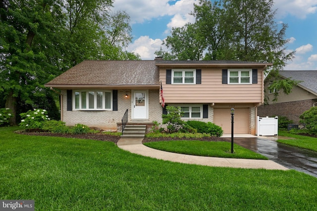 2202 Burkey Dr, Reading, PA 19610 - split level home with brick siding, driveway, an attached garage, and a front lawn