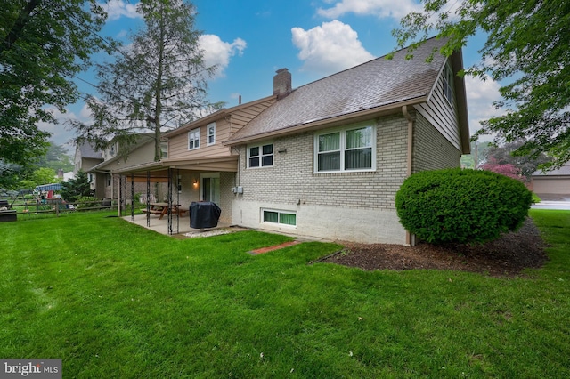 2202 Burkey Dr, Reading, PA 19610 - rear view of property with brick siding, a patio area, a chimney, a yard, and a shingled roof