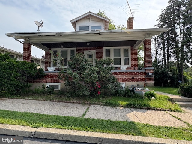 1413 Luzerne St, Reading, PA 19601 - bungalow-style house with a porch, brick siding, and a chimney