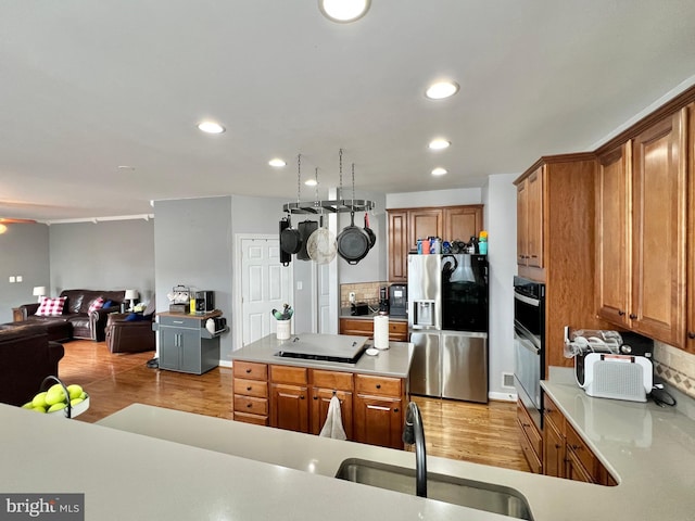 16331 Eagle Flight Cir, Woodbridge, VA 22191 - kitchen with stainless steel fridge with ice dispenser, electric stovetop, brown cabinets, decorative backsplash, and light countertops