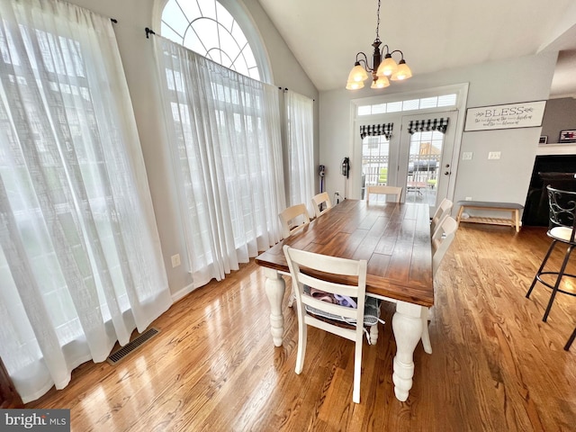 16331 Eagle Flight Cir, Woodbridge, VA 22191 - dining area featuring light wood-style floors, a chandelier, and vaulted ceiling
