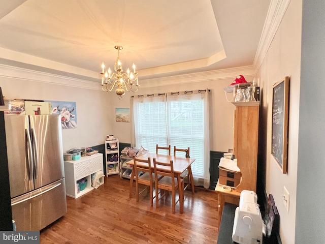 16331 Eagle Flight Cir, Woodbridge, VA 22191 - dining space featuring a tray ceiling, a chandelier, wood finished floors, and crown molding