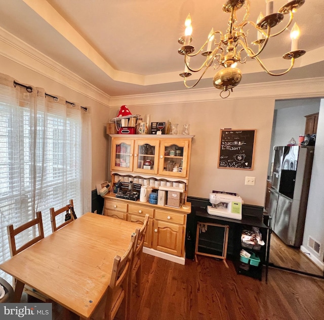 16331 Eagle Flight Cir, Woodbridge, VA 22191 - dining room featuring a chandelier, dark wood-style flooring, a raised ceiling, and crown molding