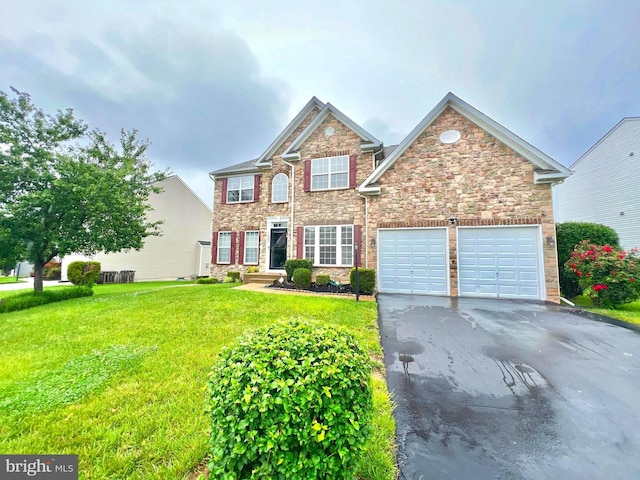 16331 Eagle Flight Cir, Woodbridge, VA 22191 - view of front facade featuring asphalt driveway, stone siding, a front yard, and a garage