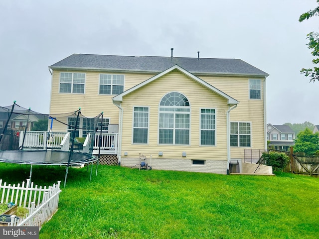 16331 Eagle Flight Cir, Woodbridge, VA 22191 - rear view of house with a trampoline, a fenced backyard, a deck, and crawl space