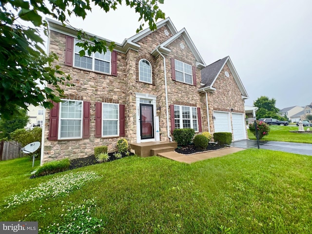 16331 Eagle Flight Cir, Woodbridge, VA 22191 - view of front of house with driveway, stone siding, a garage, and a front yard