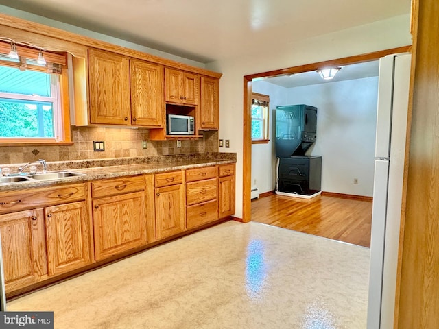 13709 Fir Tree Ln, Cresaptown, MD 21502 - kitchen featuring stainless steel microwave, tasteful backsplash, freestanding refrigerator, and healthy amount of natural light