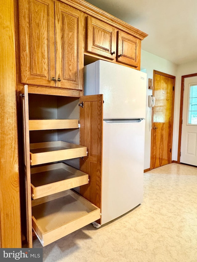 13709 Fir Tree Ln, Cresaptown, MD 21502 - kitchen featuring freestanding refrigerator, brown cabinetry, and light colored carpet