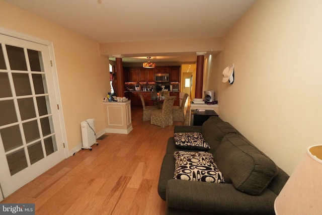 328 N Mechanic St, Cumberland, MD 21502 - living room featuring radiator and light wood-style flooring
