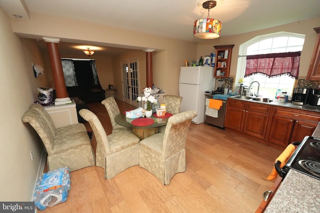 328 N Mechanic St, Cumberland, MD 21502 - dining room with ornate columns and light wood-style flooring