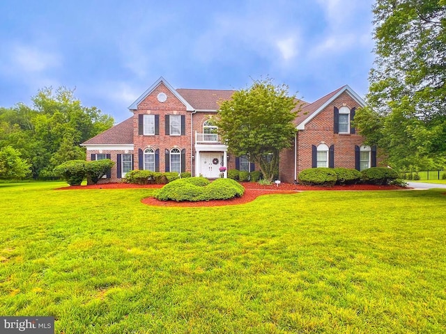 19 Pheasant Run Rd, New Hope, PA 18938 - georgian-style home featuring brick siding, a front lawn, and a balcony