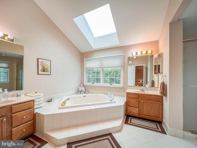 19 Pheasant Run Rd, New Hope, PA 18938 - full bathroom featuring a skylight, two vanities, a garden tub, tile patterned flooring, and plenty of natural light