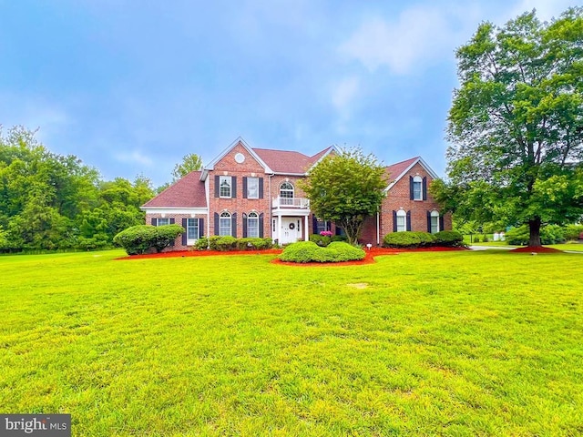 19 Pheasant Run Rd, New Hope, PA 18938 - colonial-style house with brick siding, a front lawn, and a balcony