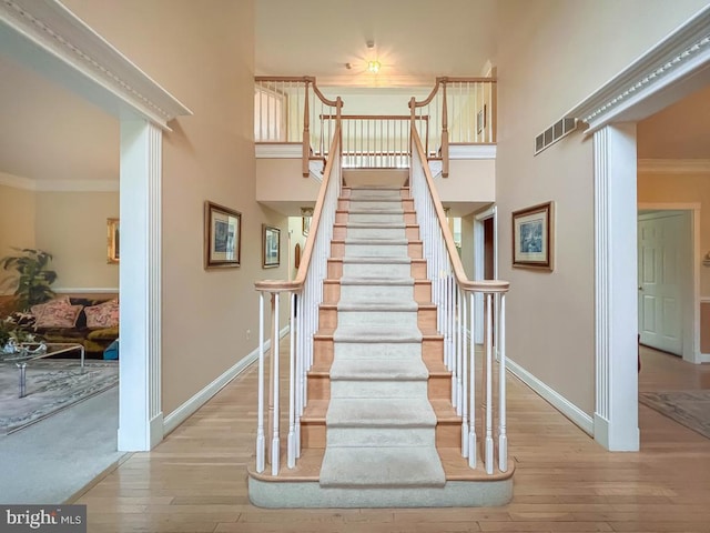 19 Pheasant Run Rd, New Hope, PA 18938 - stairs with hardwood / wood-style flooring, a high ceiling, and crown molding