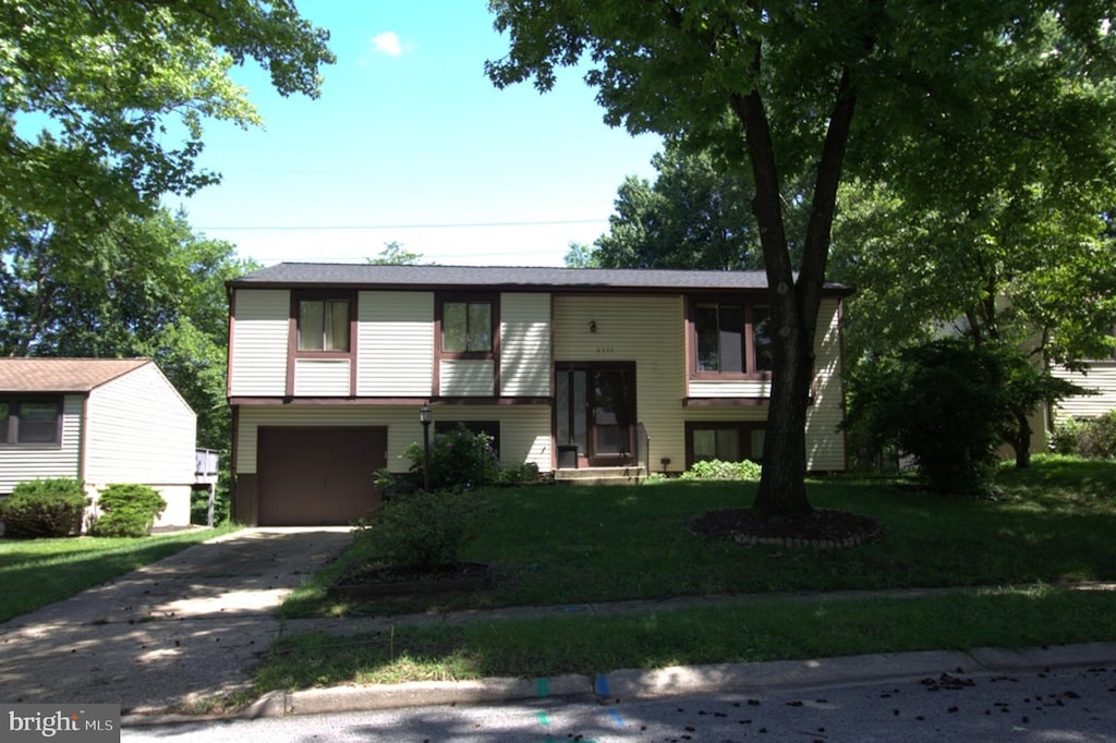 6335 Windharp Way, Columbia, MD 21045 - bi-level home with driveway, an attached garage, and a front lawn