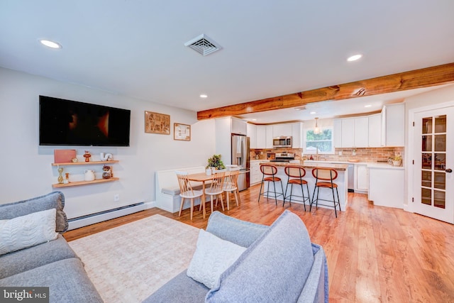215 Murray Dr, Doylestown, PA 18901 - living room featuring a baseboard radiator, recessed lighting, light wood-style floors, and beam ceiling