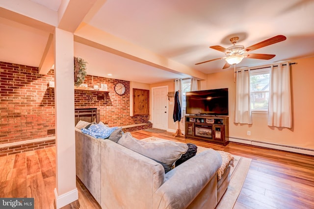 215 Murray Dr, Doylestown, PA 18901 - living area with brick wall, a baseboard heating unit, wood finished floors, ceiling fan, and a brick fireplace