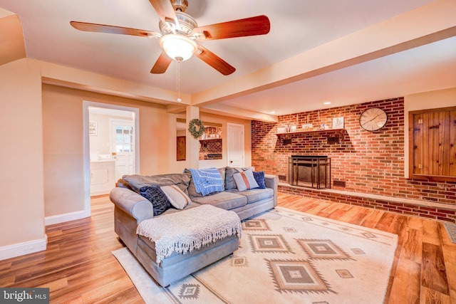 215 Murray Dr, Doylestown, PA 18901 - living area with a fireplace, wood finished floors, brick wall, and a ceiling fan