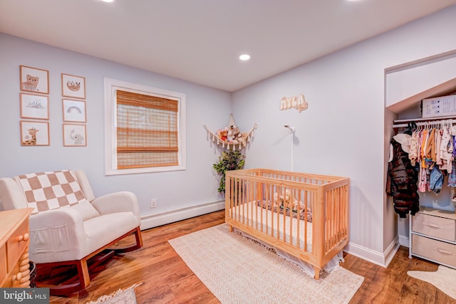 215 Murray Dr, Doylestown, PA 18901 - bedroom with a baseboard heating unit, recessed lighting, wood finished floors, a closet, and a nursery area