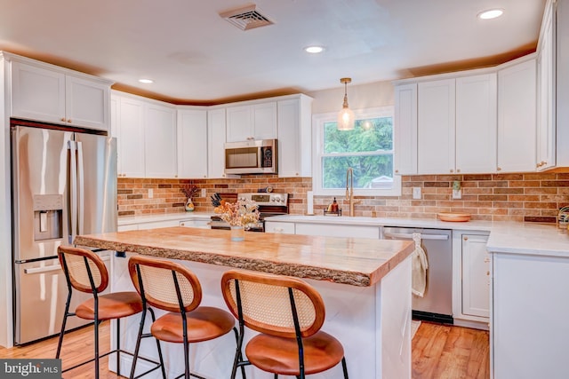 215 Murray Dr, Doylestown, PA 18901 - kitchen featuring appliances with stainless steel finishes, light countertops, white cabinets, and recessed lighting