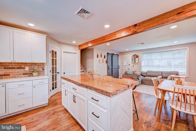 215 Murray Dr, Doylestown, PA 18901 - kitchen featuring recessed lighting, beamed ceiling, light wood-type flooring, backsplash, and light countertops