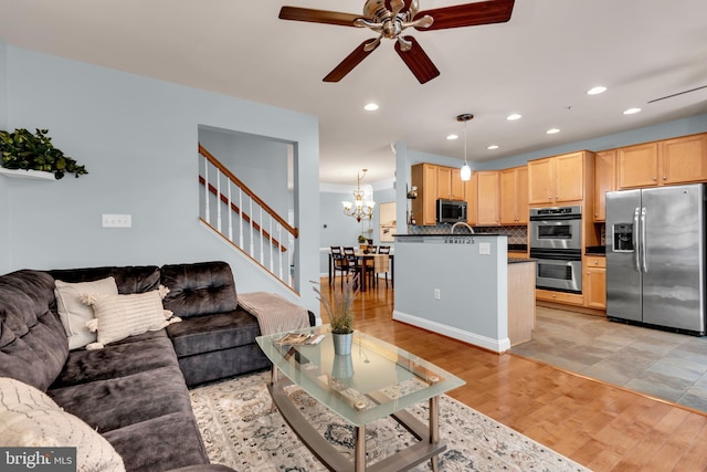 810 Broken Twig Ct, Odenton, MD 21113 - living room featuring stairway, a ceiling fan, light wood-type flooring, recessed lighting, and a chandelier