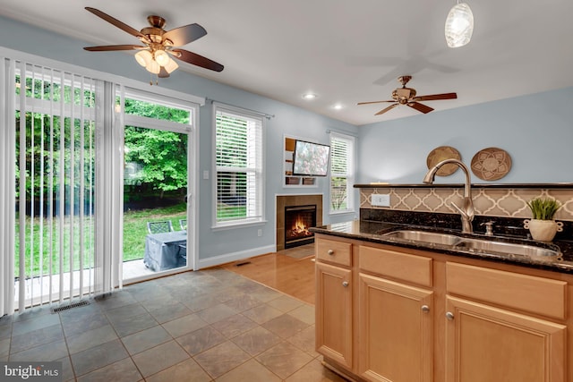 810 Broken Twig Ct, Odenton, MD 21113 - kitchen featuring a ceiling fan, dark stone countertops, a tile fireplace, backsplash, and recessed lighting