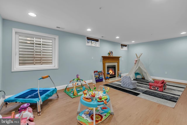 810 Broken Twig Ct, Odenton, MD 21113 - rec room with wood finished floors, recessed lighting, and a glass covered fireplace