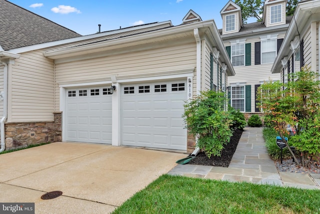 810 Broken Twig Ct, Odenton, MD 21113 - view of front of property featuring concrete driveway, a garage, stone siding, and roof with shingles
