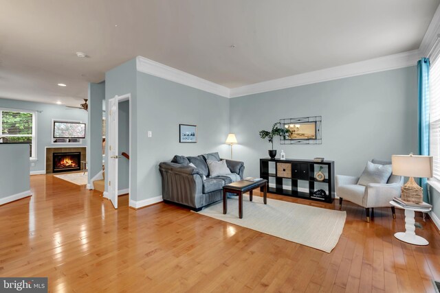 810 Broken Twig Ct, Odenton, MD 21113 - living room with light wood finished floors, a tiled fireplace, a ceiling fan, ornamental molding, and recessed lighting