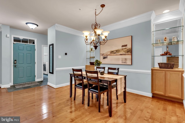 810 Broken Twig Ct, Odenton, MD 21113 - dining area featuring crown molding, a chandelier, light wood-style flooring, and washer / dryer