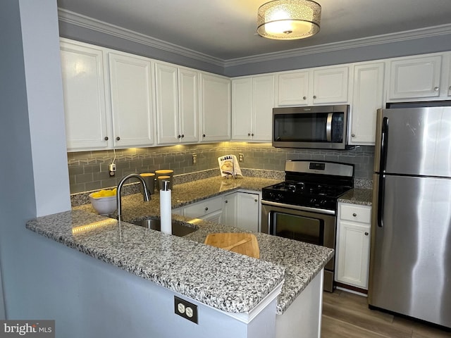 8 Tyler Falls Ct Unit C, Baltimore, MD 21209 - kitchen featuring appliances with stainless steel finishes, stone counters, white cabinetry, and crown molding