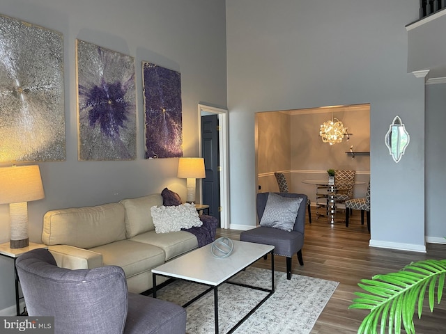 8 Tyler Falls Ct Unit C, Baltimore, MD 21209 - living room featuring a towering ceiling, wood finished floors, and a chandelier