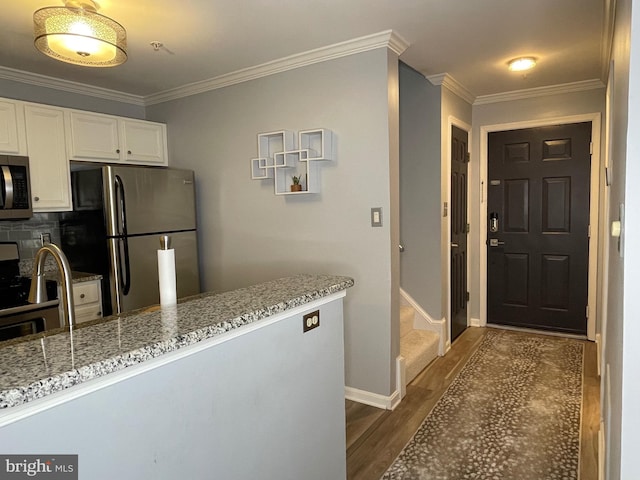 8 Tyler Falls Ct Unit C, Baltimore, MD 21209 - kitchen featuring stainless steel appliances, dark wood-style floors, white cabinetry, light stone counters, and ornamental molding