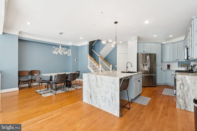 2009 Magarity Ct, Falls Church, VA 22043 - kitchen with stainless steel appliances, a chandelier, ornamental molding, light wood-style floors, and pendant lighting