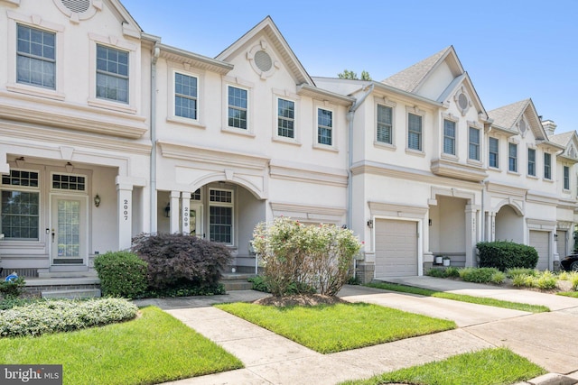 2009 Magarity Ct, Falls Church, VA 22043 - townhome / multi-family property featuring an attached garage, stucco siding, and concrete driveway
