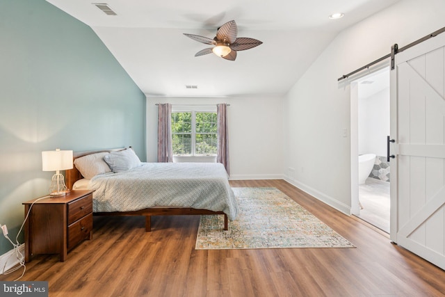 2009 Magarity Ct, Falls Church, VA 22043 - bedroom featuring a barn door, lofted ceiling, wood finished floors, a ceiling fan, and recessed lighting