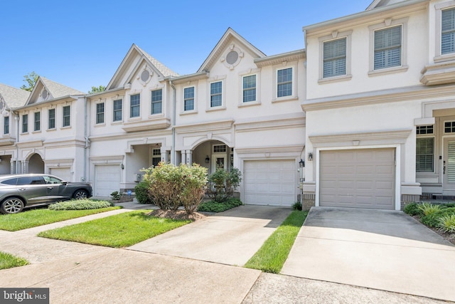2009 Magarity Ct, Falls Church, VA 22043 - view of property featuring a garage, concrete driveway, and stucco siding