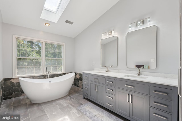 2009 Magarity Ct, Falls Church, VA 22043 - full bath featuring lofted ceiling, a skylight, double vanity, wainscoting, and a freestanding bath