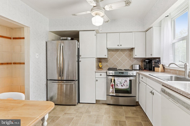694 Davisville Rd, Warminster, PA 18974 - kitchen with appliances with stainless steel finishes, white cabinets, backsplash, light countertops, and ceiling fan