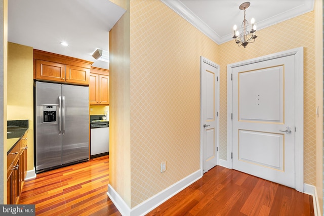1701 Locust St Unit 2015, Philadelphia, PA 19103 - kitchen featuring stainless steel refrigerator with ice dispenser, white dishwasher, ornamental molding, wood finished floors, and a chandelier