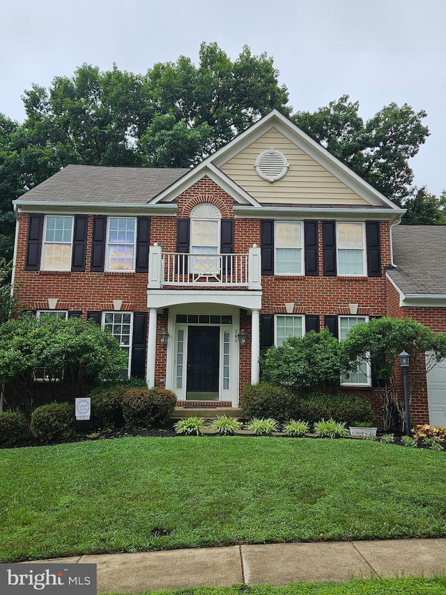 249 Whitworth Dr, Culpeper, VA 22701 - georgian-style home featuring a front yard, a balcony, and brick siding