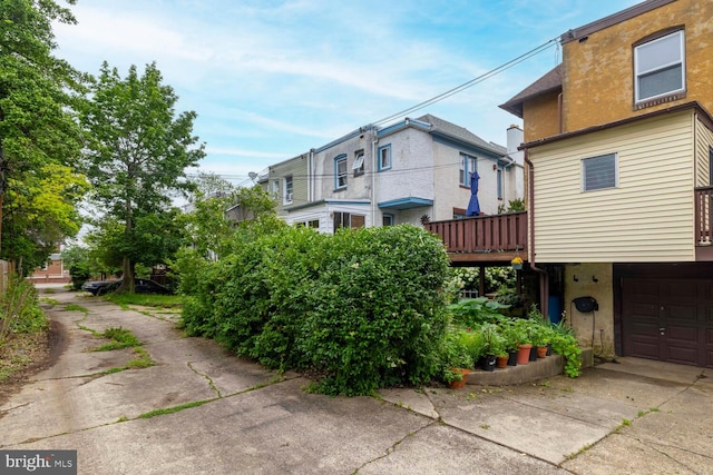 627 E Allens Ln, Philadelphia, PA 19119 - view of side of home with driveway, a garage, stucco siding, and a deck