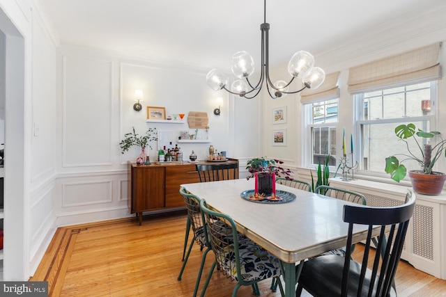 627 E Allens Ln, Philadelphia, PA 19119 - dining room with a decorative wall, a chandelier, light wood-type flooring, and crown molding