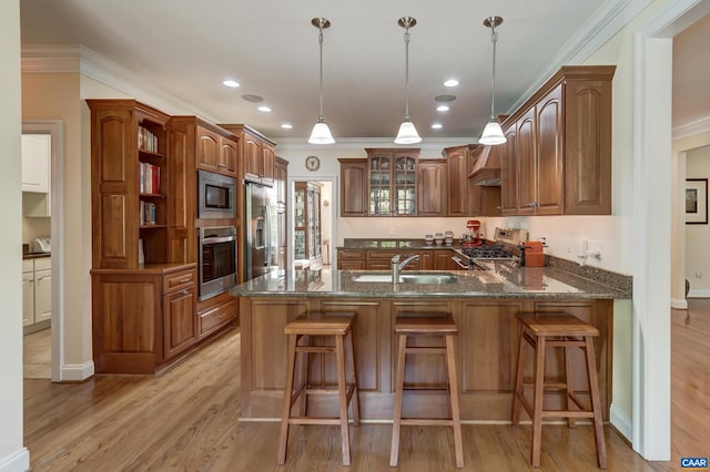 455 Foxdale Ln, Charlottesville, VA 22903 - kitchen with stainless steel appliances, ornamental molding, a peninsula, dark stone counters, and light wood finished floors