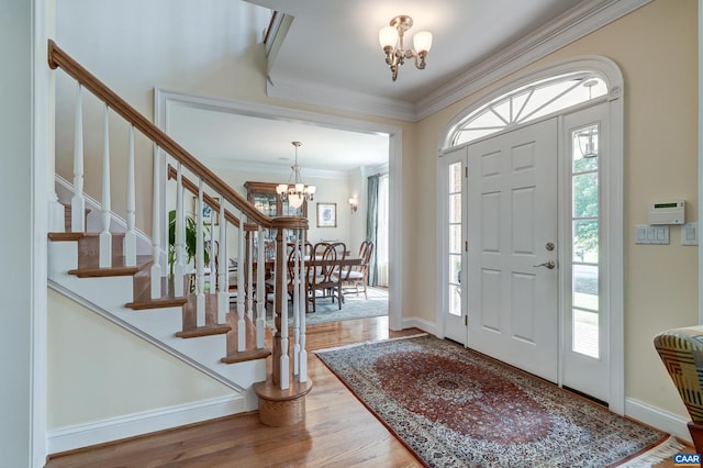 455 Foxdale Ln, Charlottesville, VA 22903 - foyer featuring a chandelier, stairs, wood finished floors, and crown molding