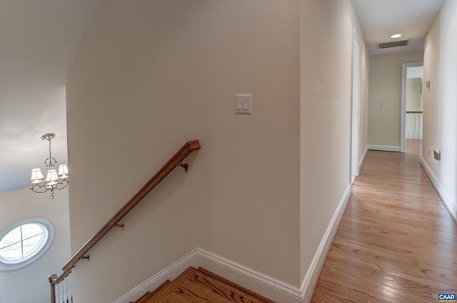 455 Foxdale Ln, Charlottesville, VA 22903 - corridor featuring light wood-style floors, a chandelier, and an upstairs landing