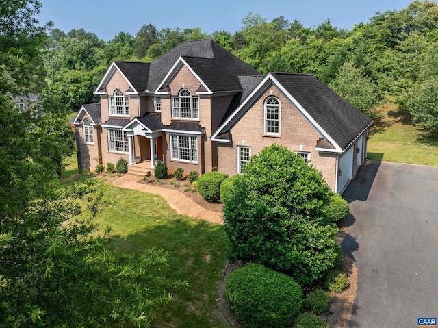 455 Foxdale Ln, Charlottesville, VA 22903 - traditional-style house featuring brick siding, driveway, a front yard, and an attached garage