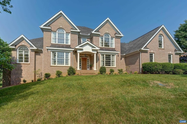 455 Foxdale Ln, Charlottesville, VA 22903 - traditional-style house with brick siding, a front yard, and a shingled roof