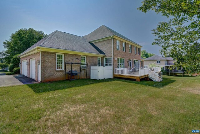 455 Foxdale Ln, Charlottesville, VA 22903 - back of property with brick siding, a yard, a deck, a shingled roof, and asphalt driveway